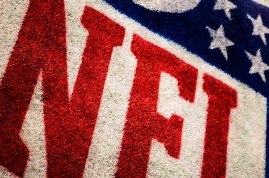 Close up of the NFL logo on turf