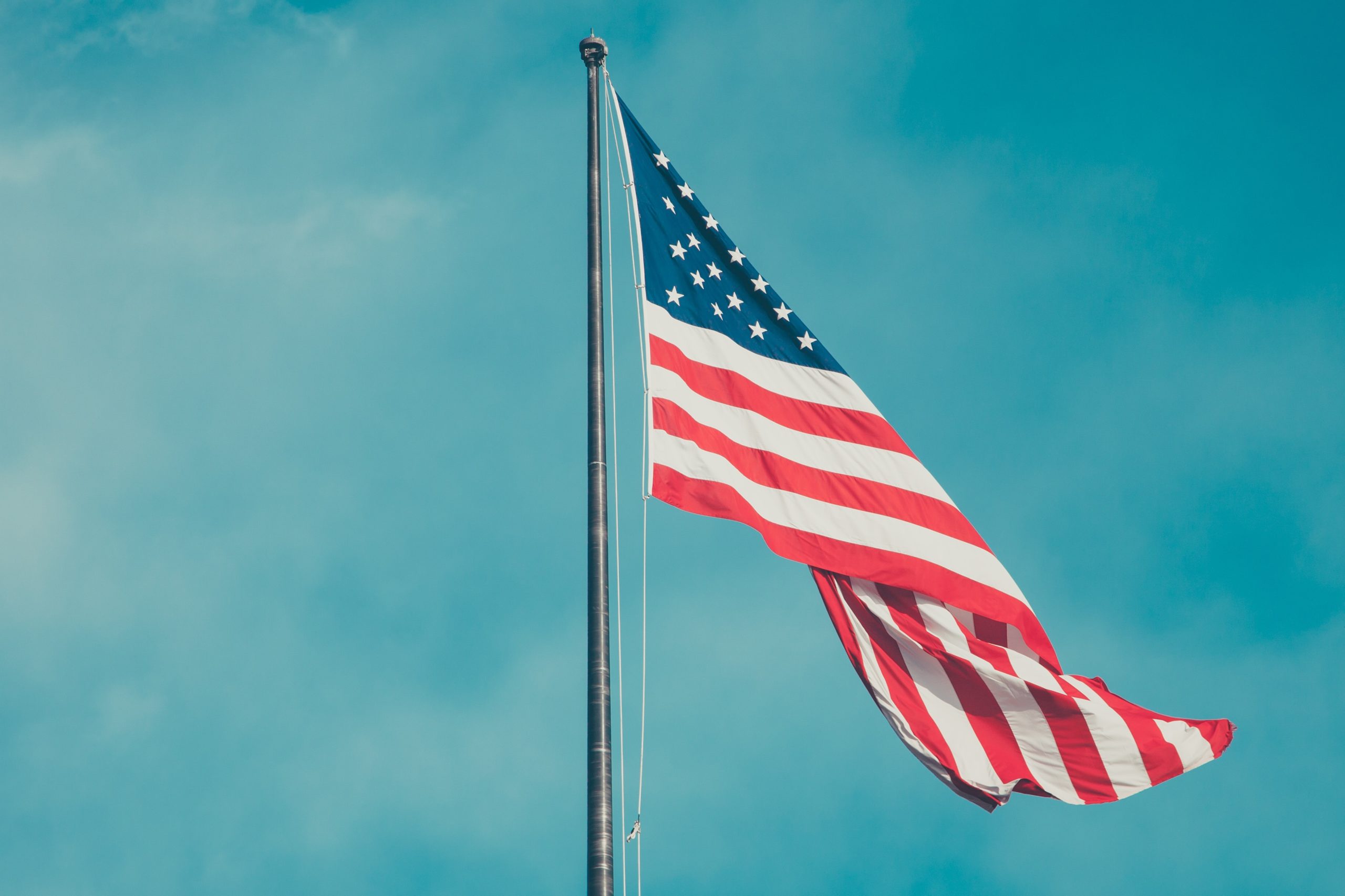 An American flag against a blue sky