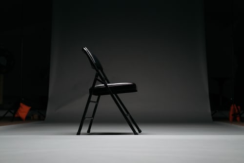 An empty chair representing a deceased spouse and the importance of proper tax and estate planning