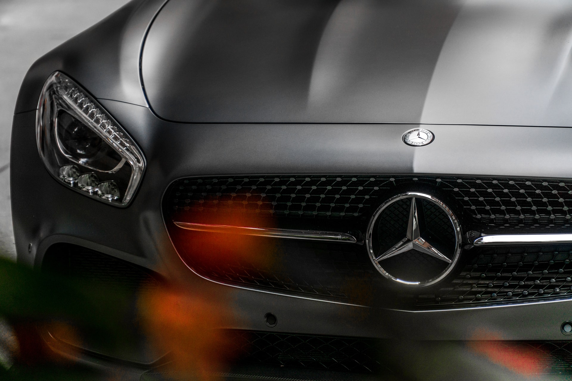 A closeup of a Mercedes Benz emblem