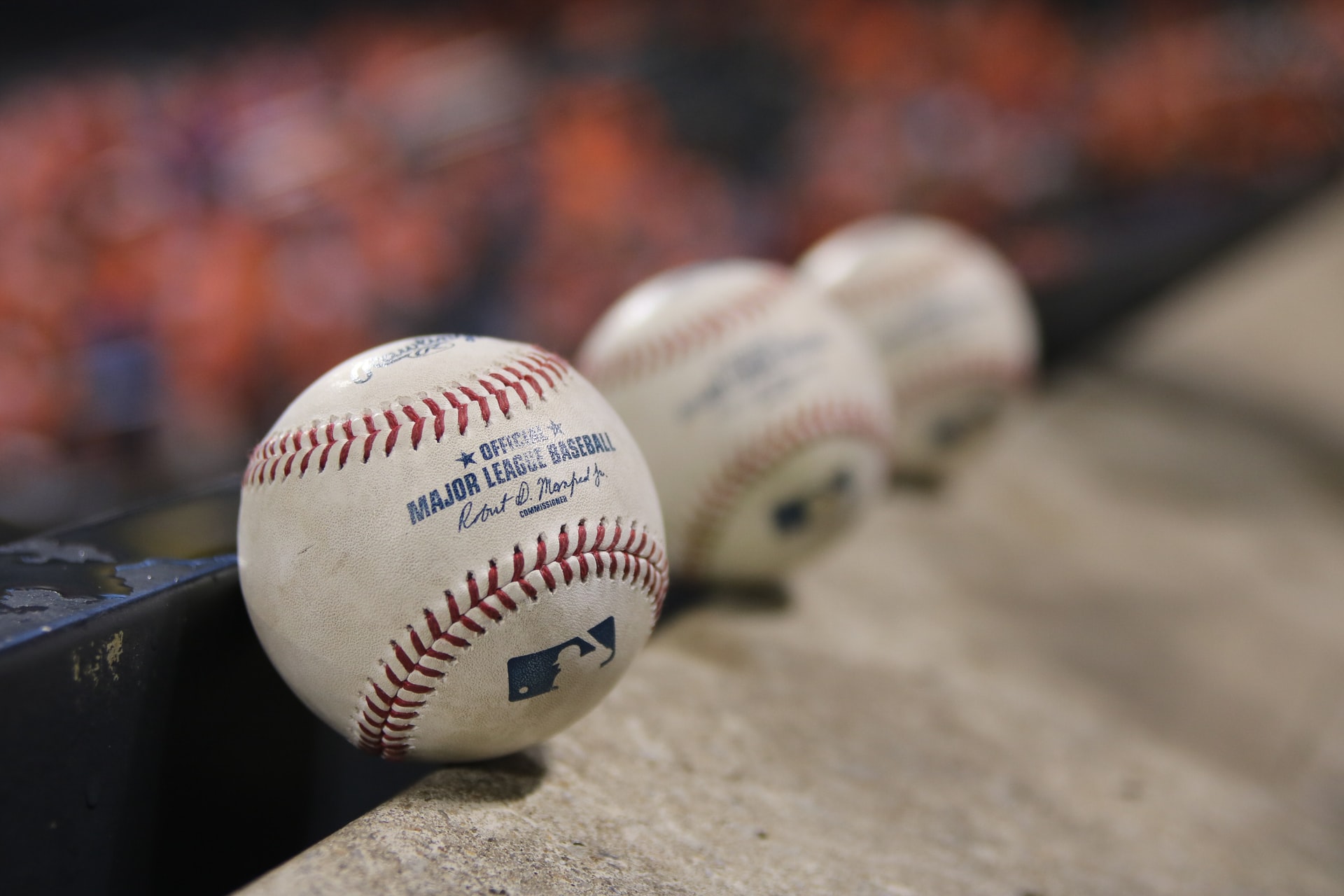 A row of MLB baseballs lined up representing a look ahead to the return of professional sports in light of COVID-19
