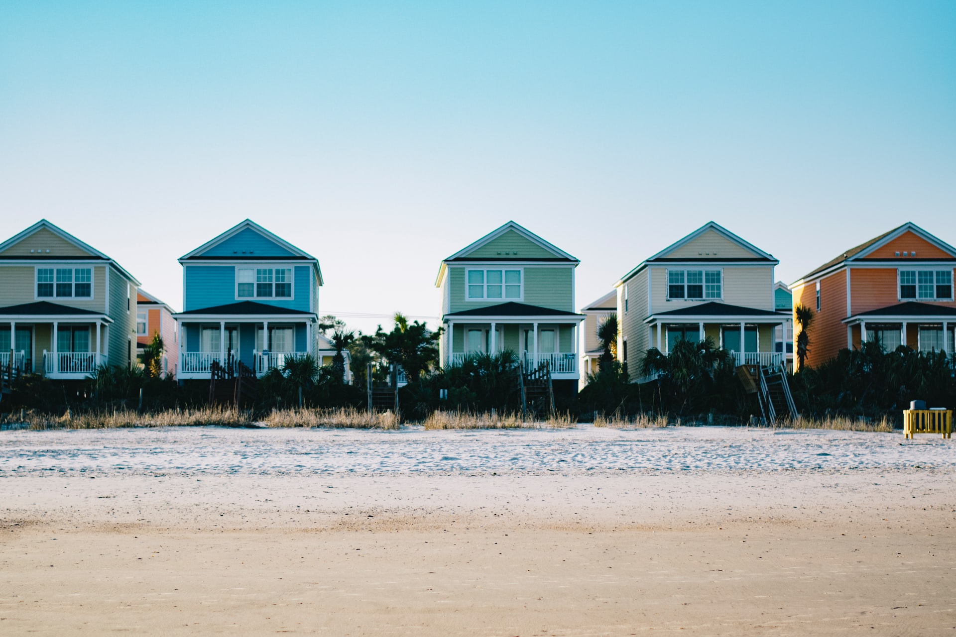A row of houses on a beach representing snowbird properties in the U.S.