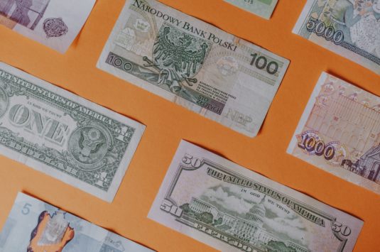 Banknotes in different international currencies representing a currency exchange scam