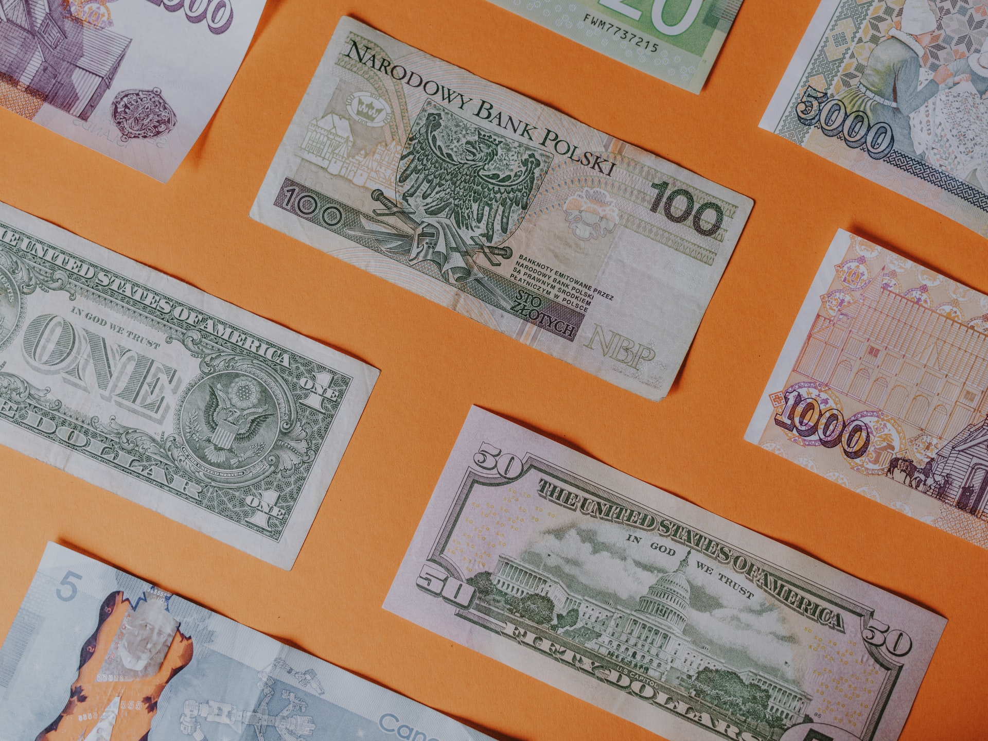 Banknotes in different international currencies representing a currency exchange scam