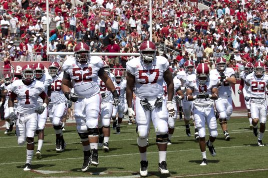 Players in a SEC NCAA football game representing the compensation of student athletes